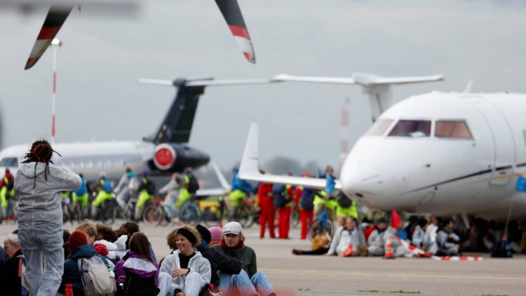 Climate activists swarm private jets at Amsterdam airport to protest pollution